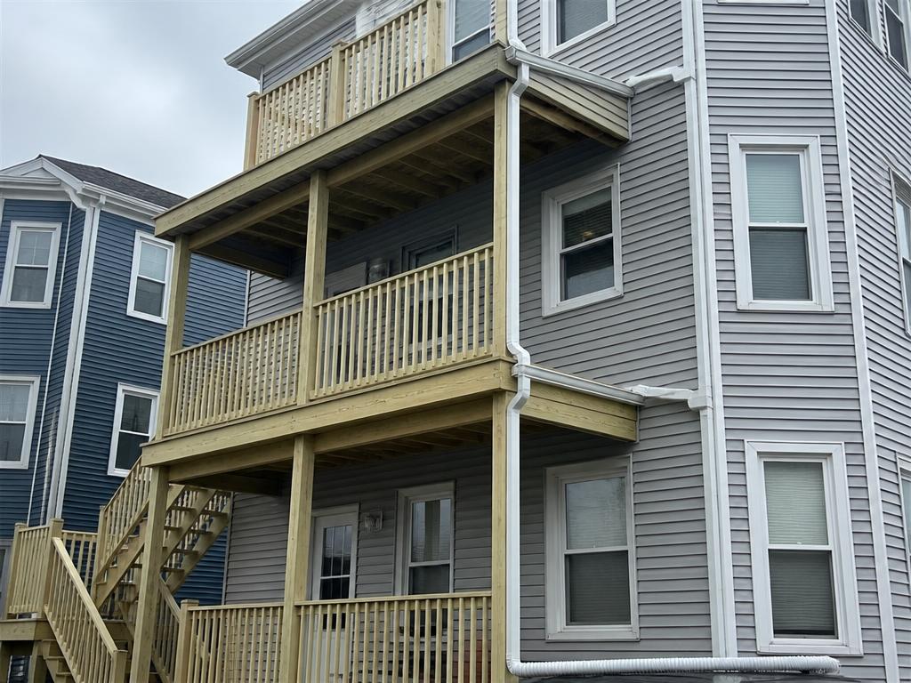 Roofing project near South Boston, MA — Rear porch gutters and downspouts — South Boston, MA